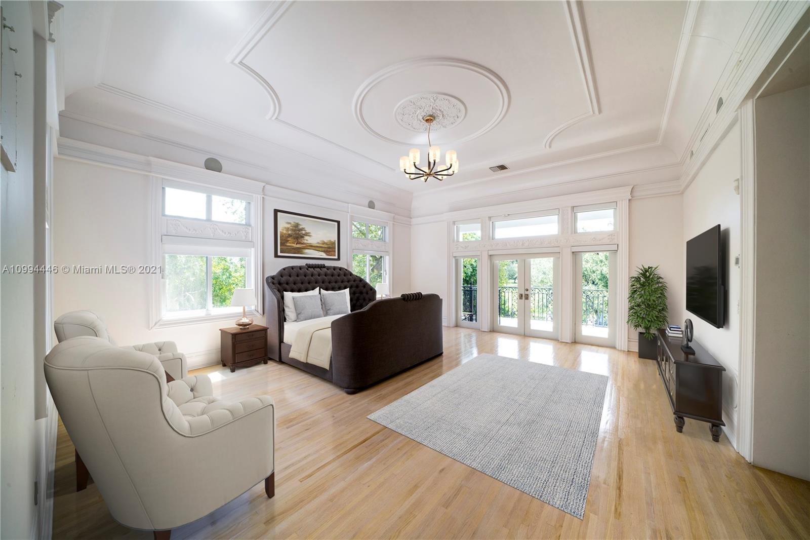 3916 Granada Boulevard Coral Gables, FL 33134 - Photo 42 of 75 a living room with furniture a flat screen tv and a floor to ceiling window