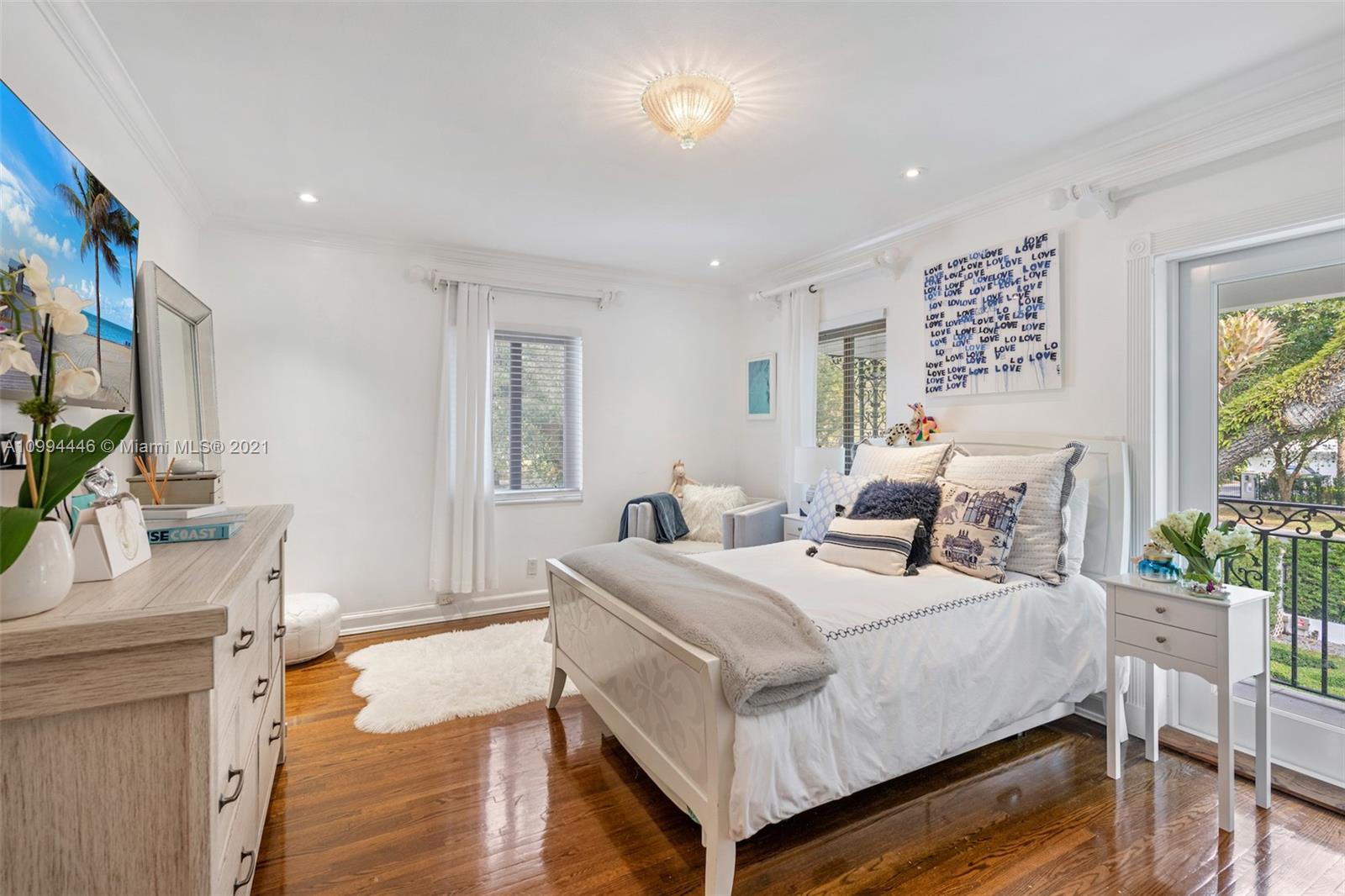 3916 Granada Boulevard Coral Gables, FL 33134 - Photo 50 of 75 a bedroom with a bed and a flat screen tv