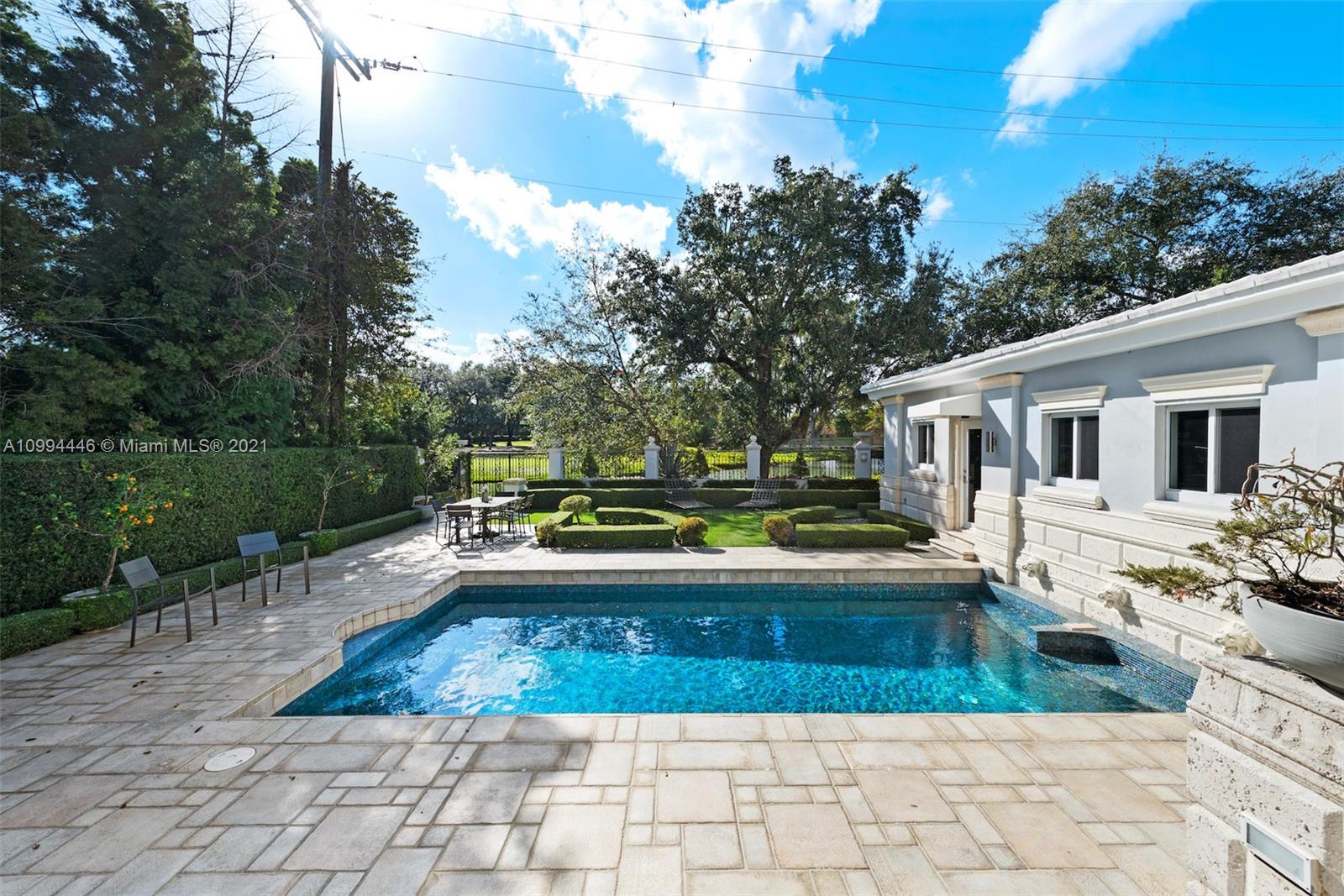 3916 Granada Boulevard Coral Gables, FL 33134 - Photo 57 of 75 a view of a house with pool fire pit a yard and a patio