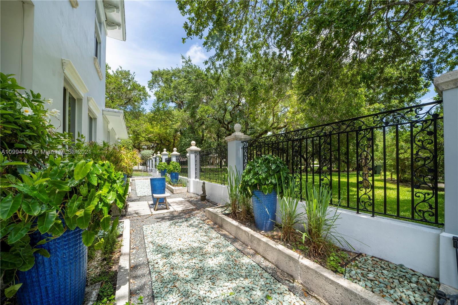 3916 Granada Boulevard Coral Gables, FL 33134 - Photo 60 of 75 a view of a yard with plants and large trees