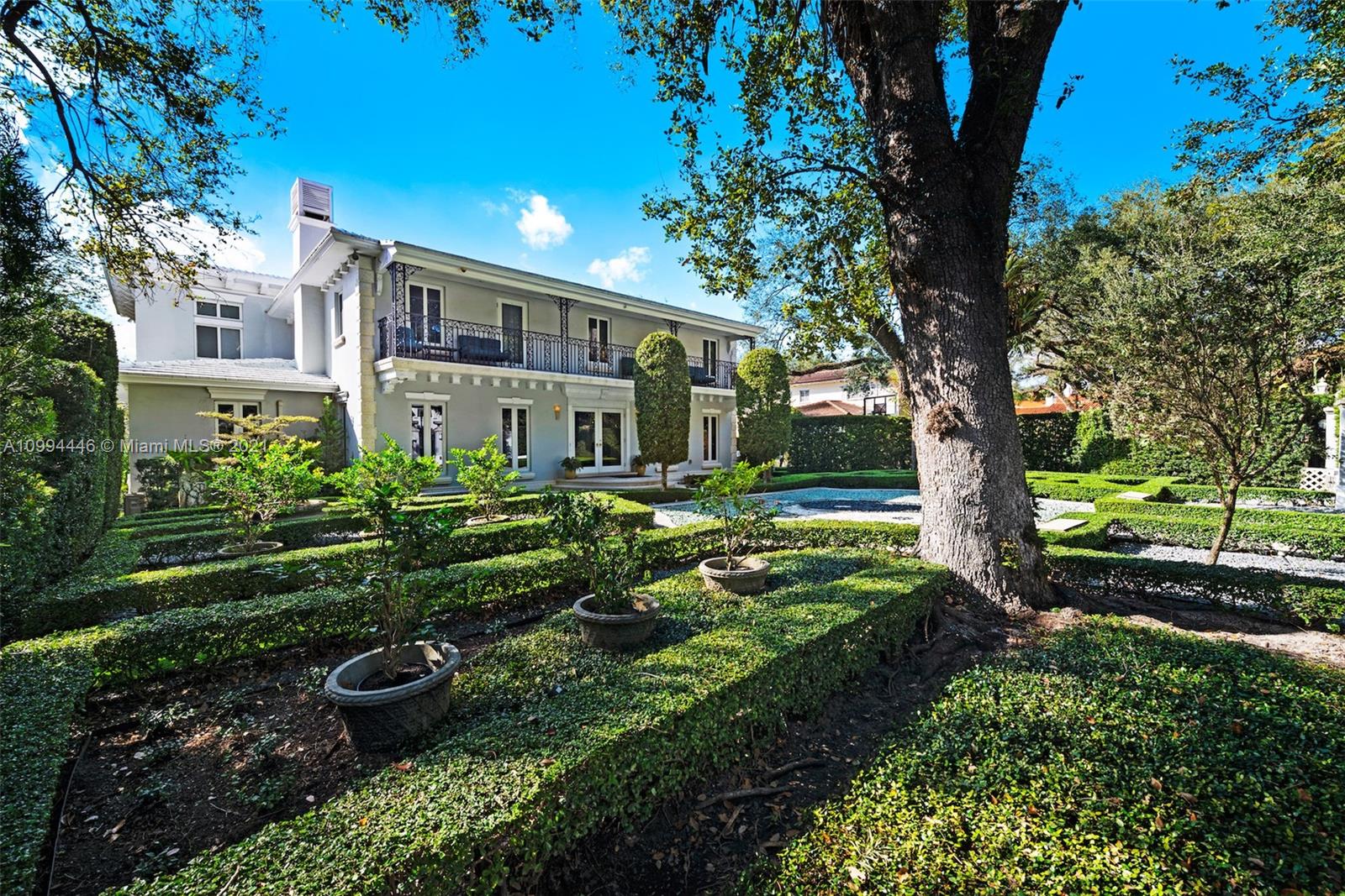 3916 Granada Boulevard Coral Gables, FL 33134 - Photo 8 of 75 a front view of a house with garden