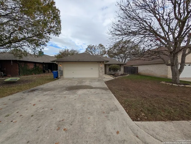 a view of a house with a yard and garage