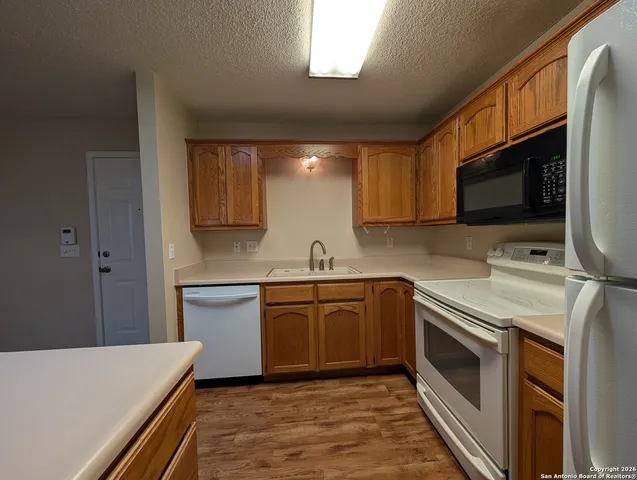 a kitchen with stainless steel appliances granite countertop a sink and a stove top oven