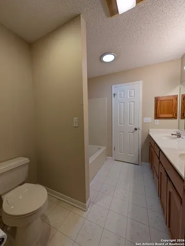 a bathroom with a granite countertop sink a toilet and granite