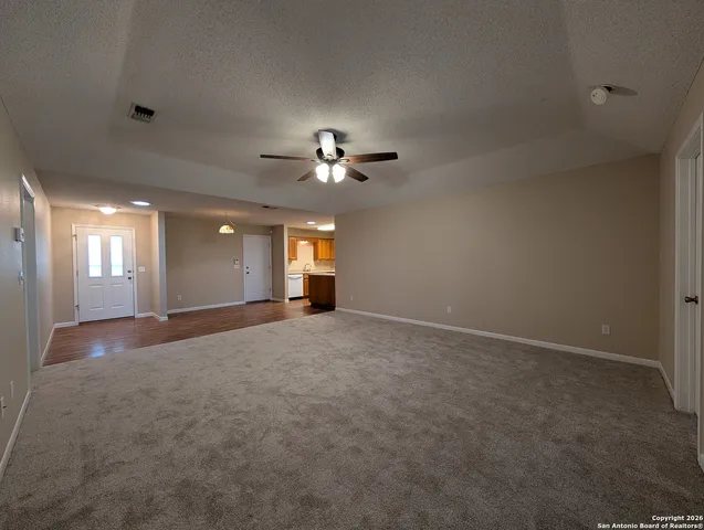 a view of a livingroom with a ceiling fan and window