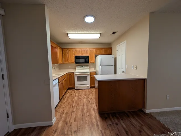 a kitchen with stainless steel appliances a refrigerator and a stove top oven