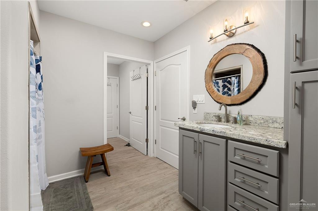 22172 North Olmito Road Rio Hondo, TX 78583 - Photo 17 of 33 a bathroom with a toilet a sink and a mirror