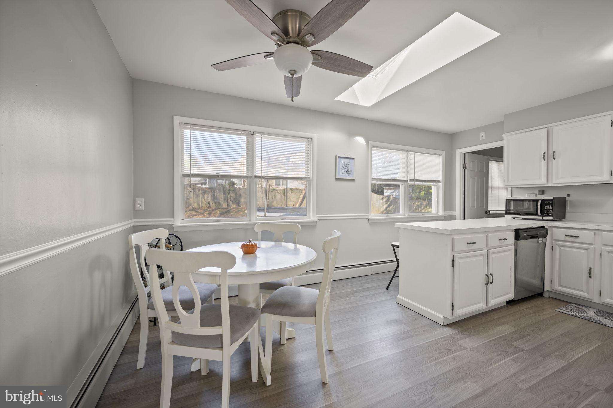 3 Leymar Road Glen Burnie, MD 21060 - Photo 20 of 60 a kitchen with a table chairs cabinets and wooden floor