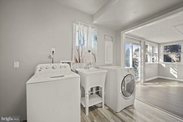 a view of a workspace with furniture and wooden floor