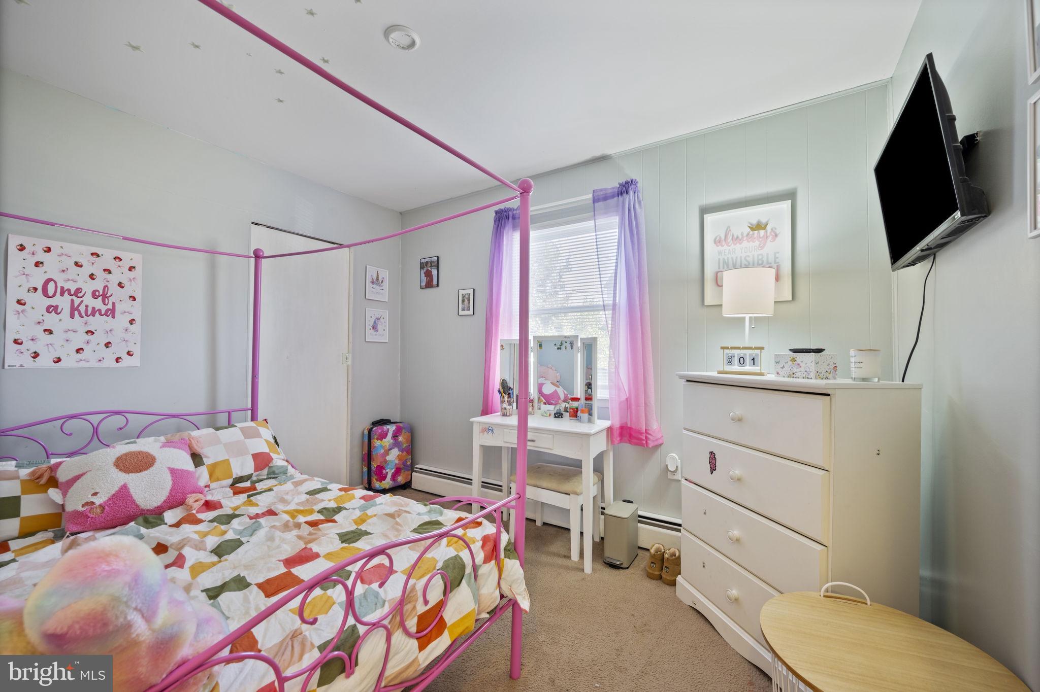 3 Leymar Road Glen Burnie, MD 21060 - Photo 37 of 60 a bedroom with a bed and a flat tv screen on dresser