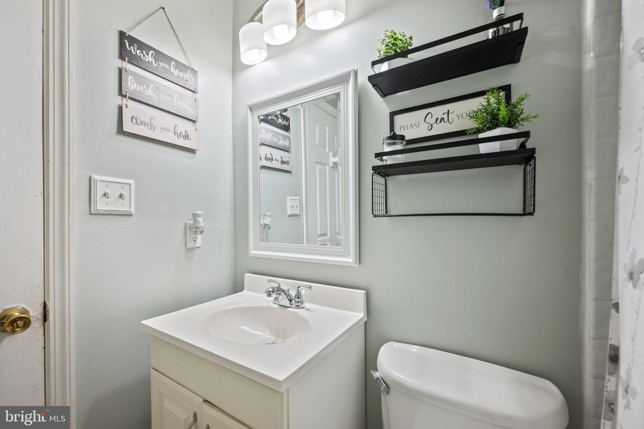 3 Leymar Road Glen Burnie, MD 21060 - Photo 40 of 60 a bathroom with a toilet a sink and mirror