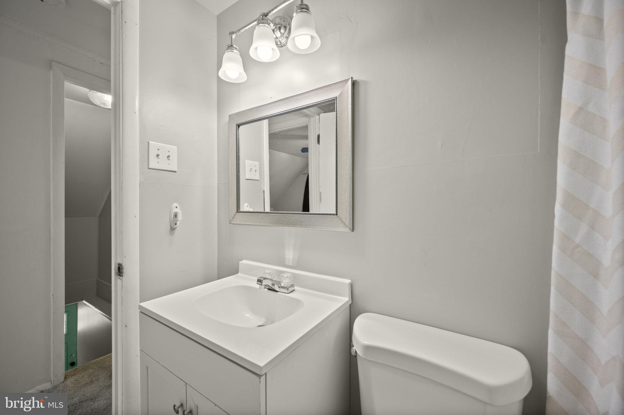 3 Leymar Road Glen Burnie, MD 21060 - Photo 49 of 60 a bathroom with a toilet a sink and mirror
