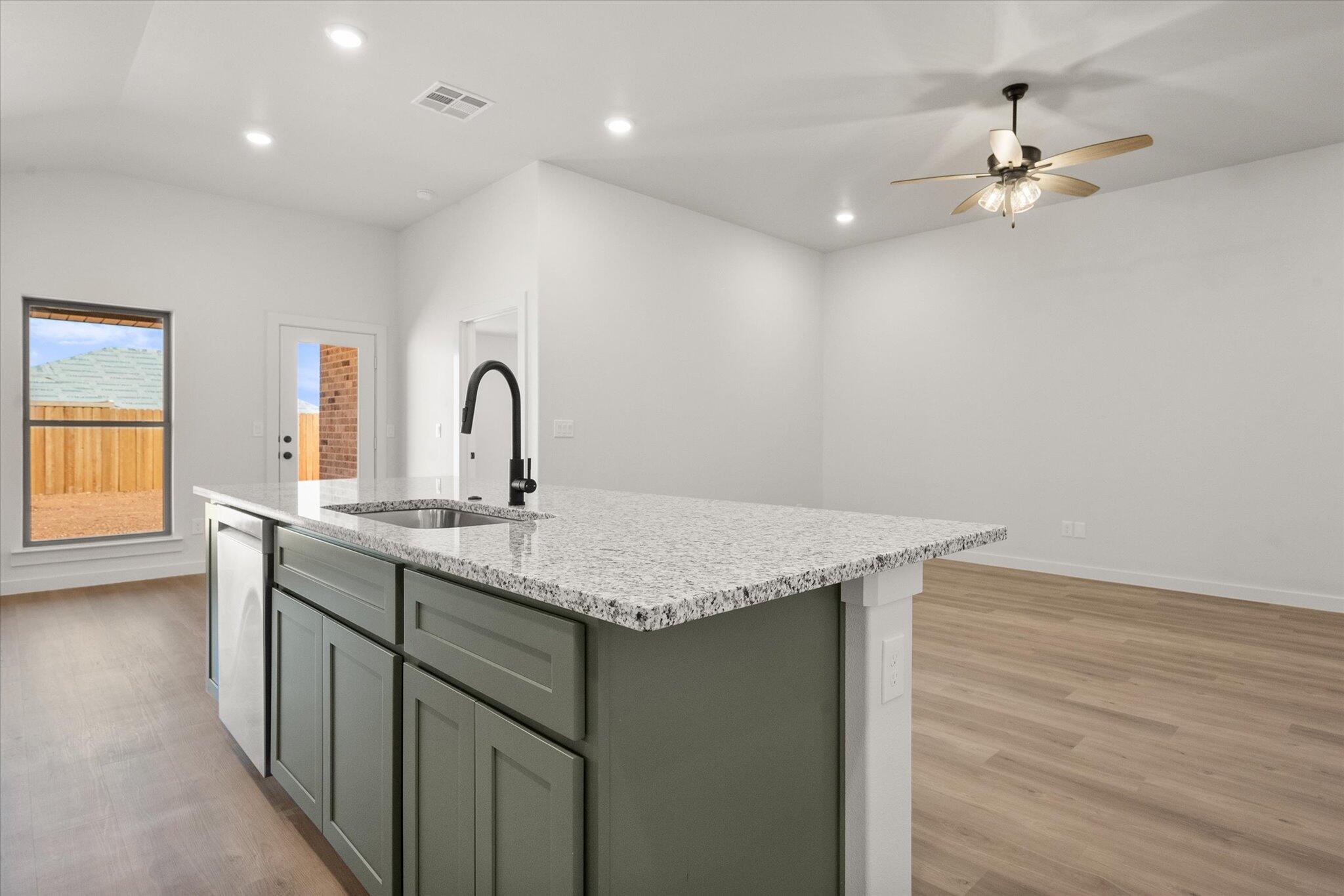 2422 Aberdeen Avenue Wolfforth, TX 79382 - Photo 12 of 23 a kitchen with a sink cabinets and wooden floor