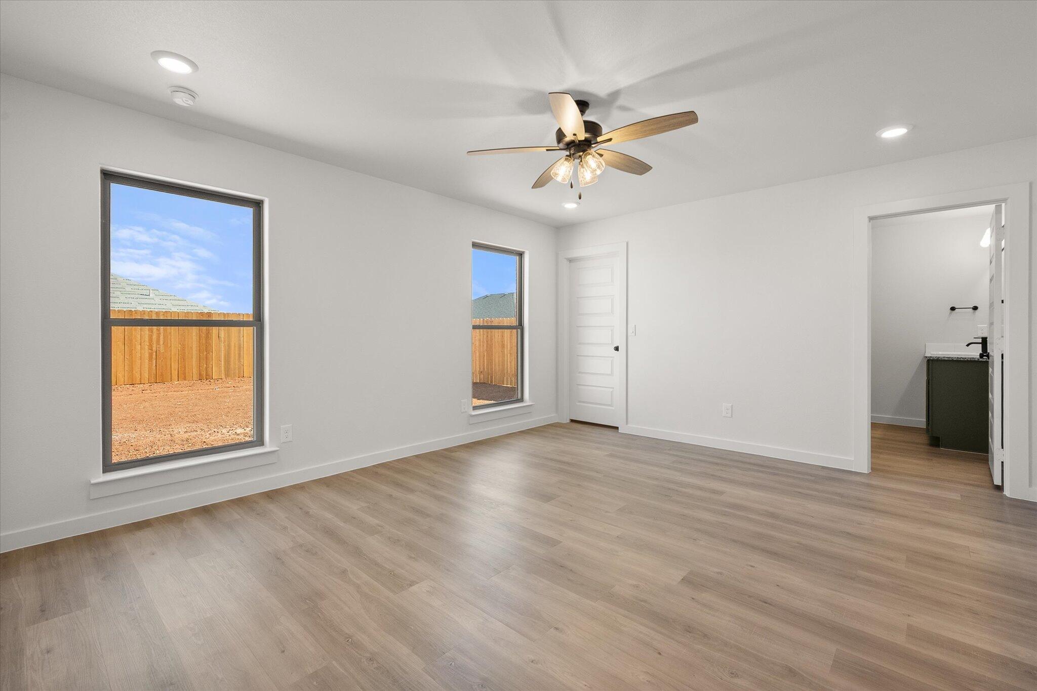 2422 Aberdeen Avenue Wolfforth, TX 79382 - Photo 14 of 23 a view of an empty room with window and wooden floor