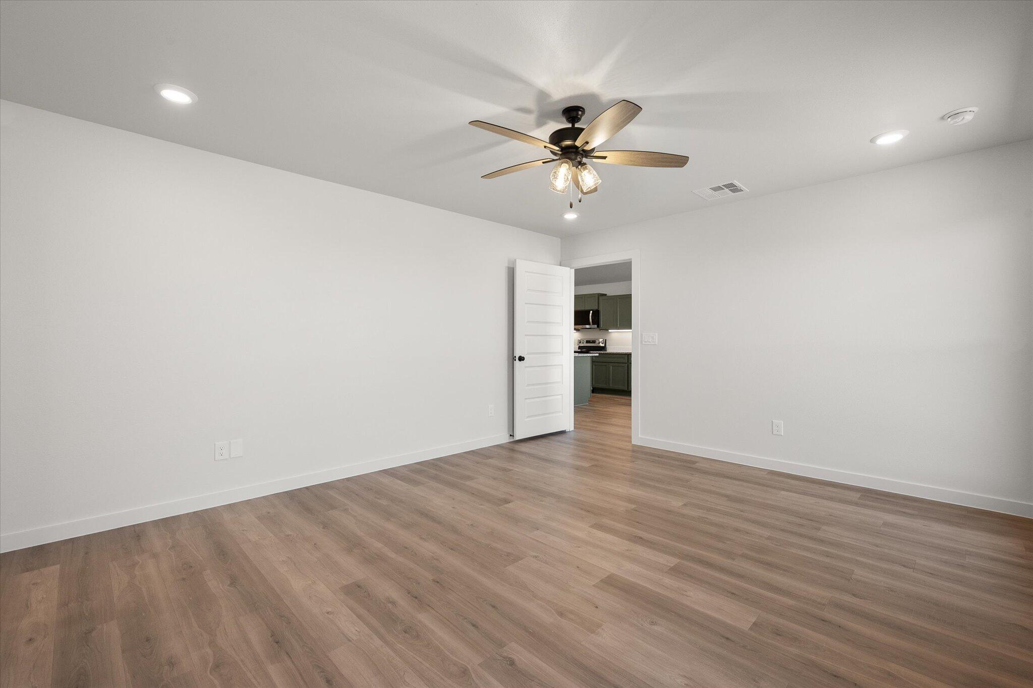 2422 Aberdeen Avenue Wolfforth, TX 79382 - Photo 15 of 23 wooden floor in an empty room with a window