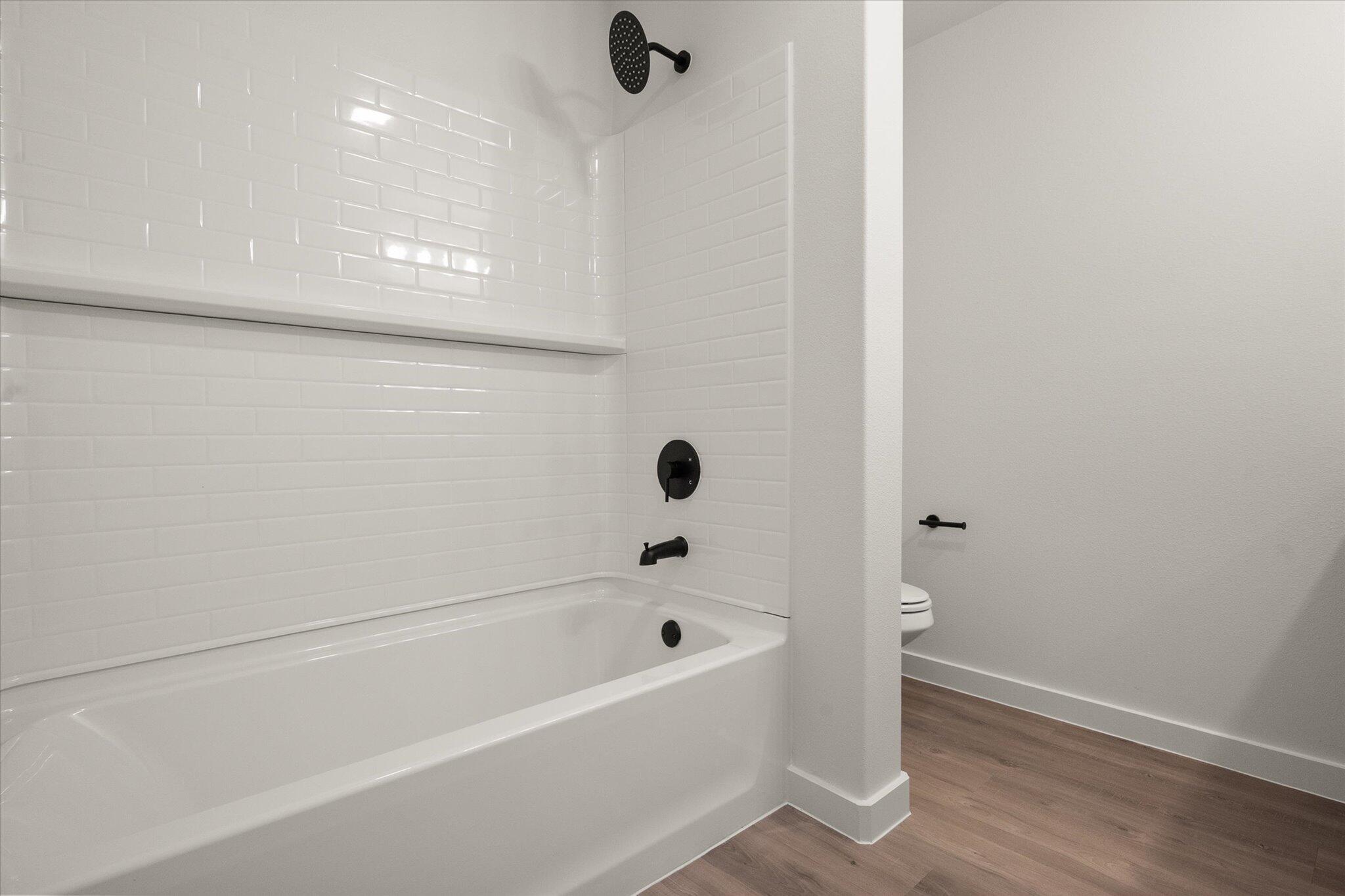 2422 Aberdeen Avenue Wolfforth, TX 79382 - Photo 17 of 23 a bathroom with a bathtub and shower