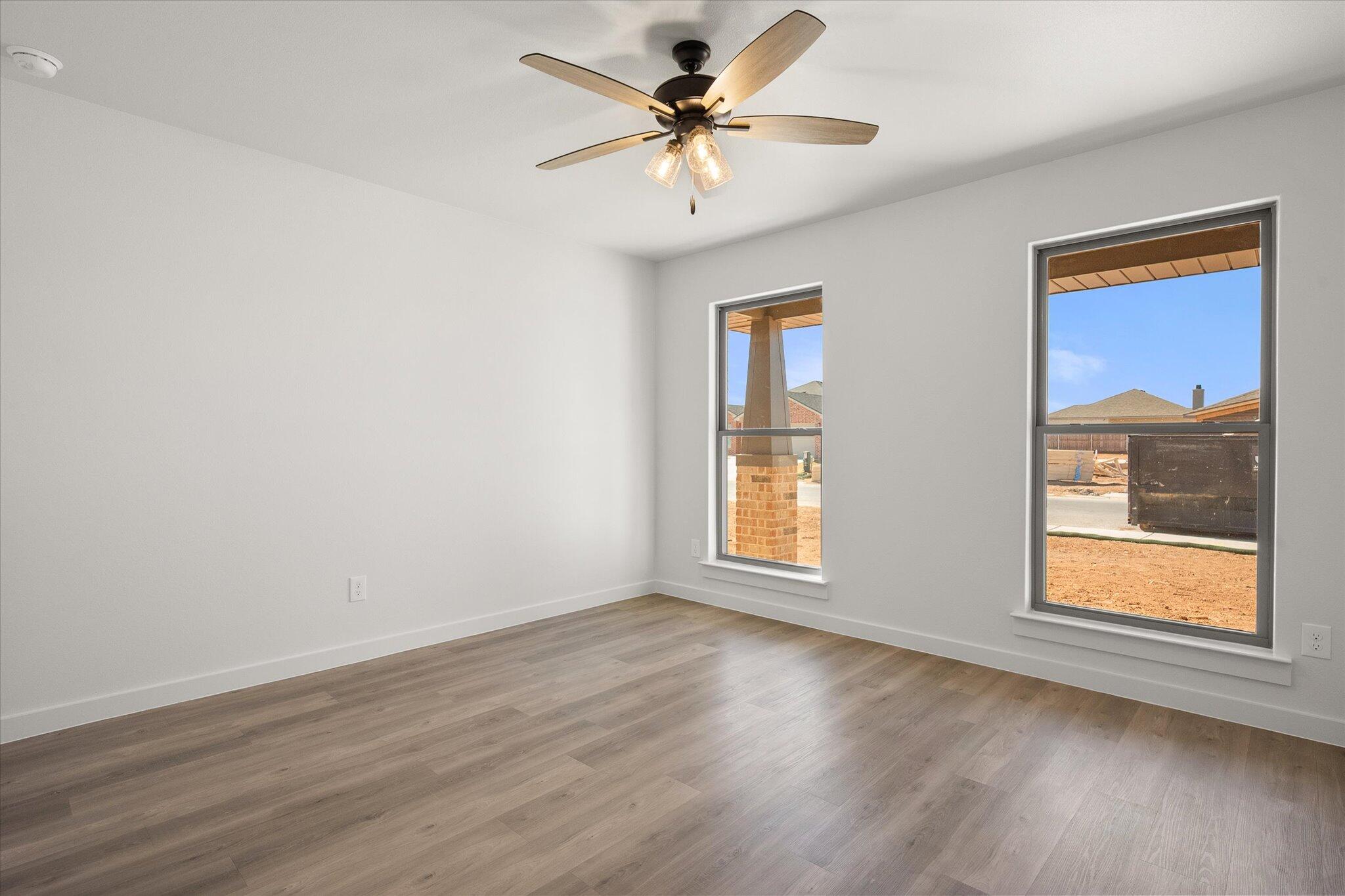 2422 Aberdeen Avenue Wolfforth, TX 79382 - Photo 18 of 23 a view of an empty room with a window and wooden floor