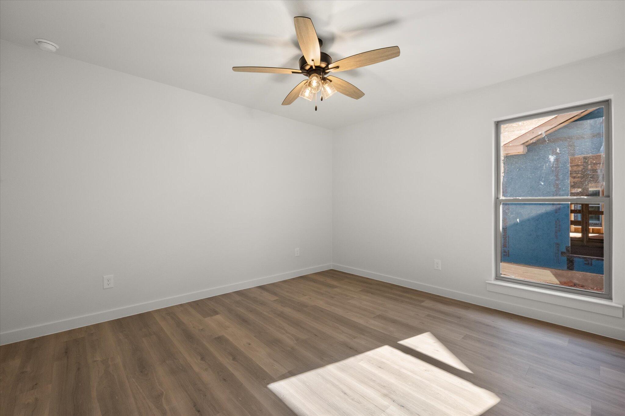 2422 Aberdeen Avenue Wolfforth, TX 79382 - Photo 19 of 23 wooden floor in an empty room with a window