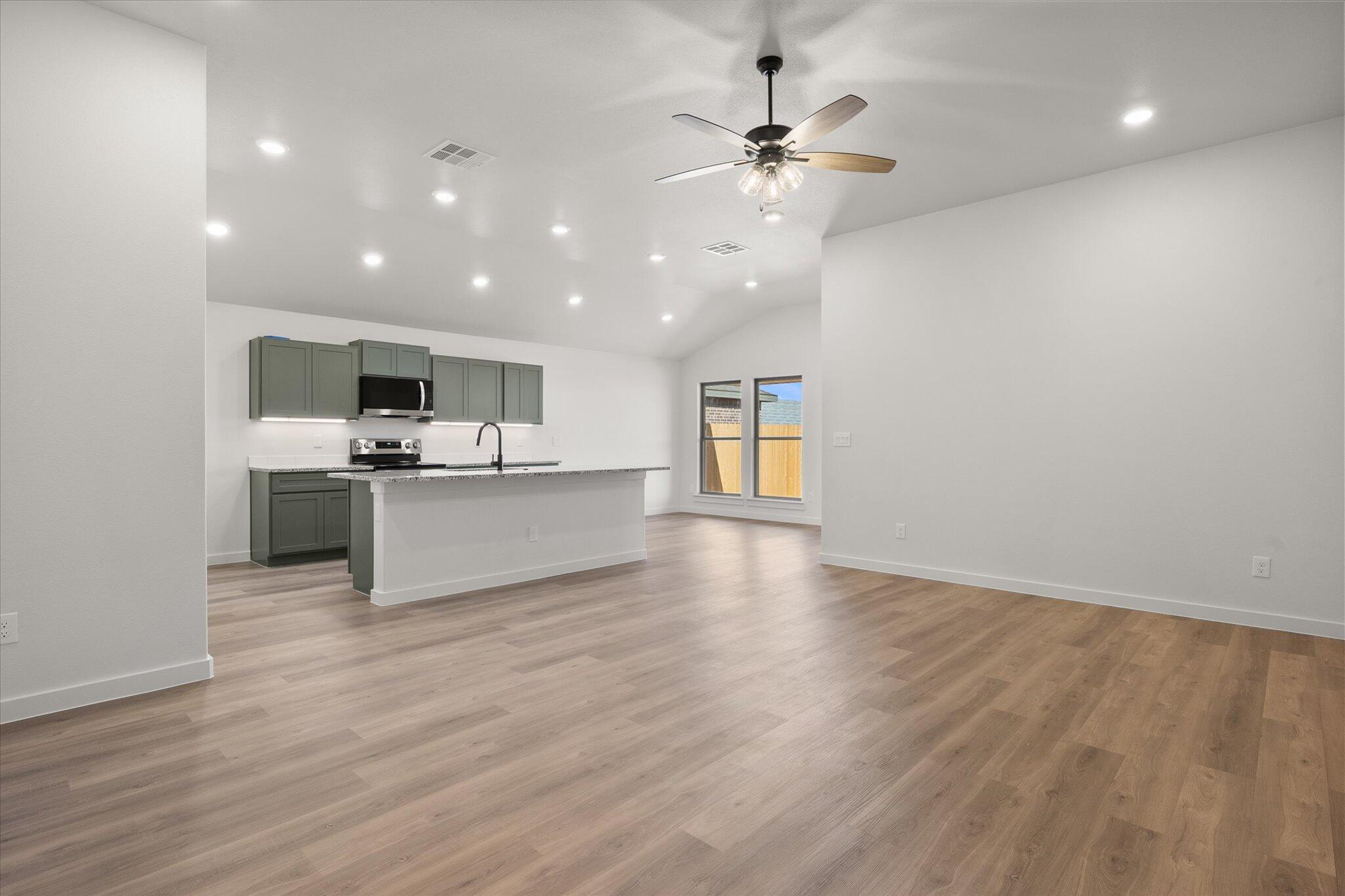 2422 Aberdeen Avenue Wolfforth, TX 79382 - Photo 3 of 23 a view of a kitchen with a sink cabinets and wooden floor