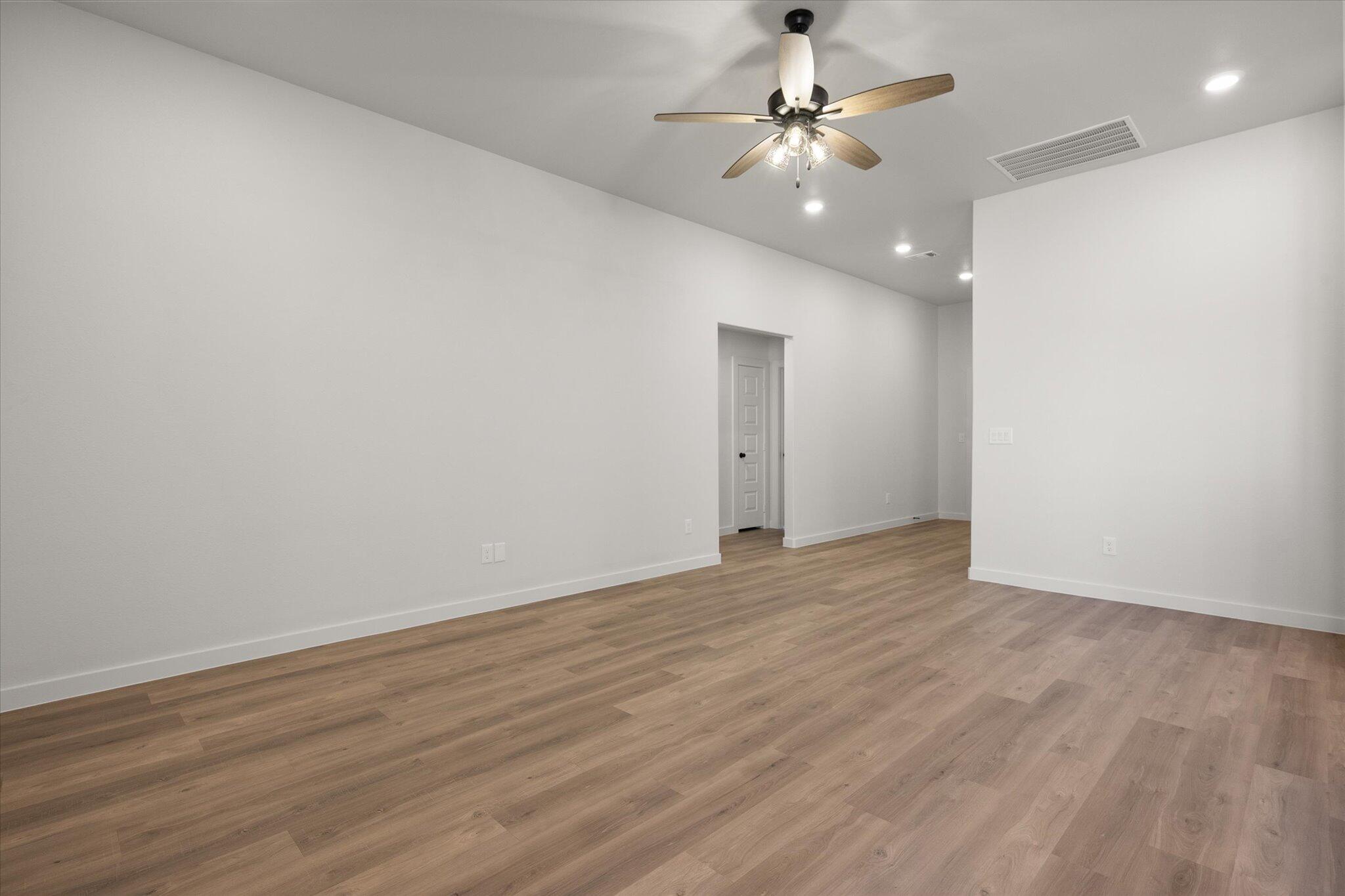 2422 Aberdeen Avenue Wolfforth, TX 79382 - Photo 5 of 23 a view of an empty room with a ceiling fan and closet