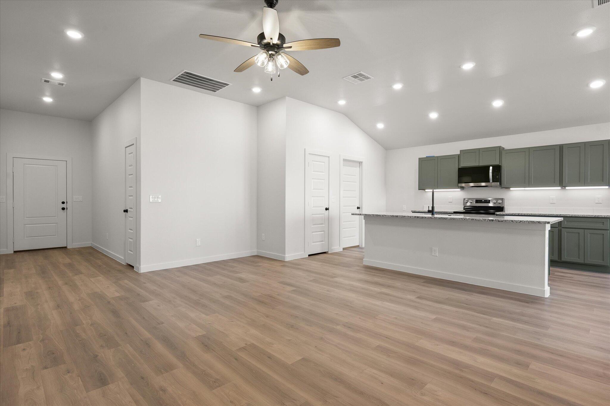 2422 Aberdeen Avenue Wolfforth, TX 79382 - Photo 6 of 23 a view of kitchen with kitchen island stainless steel appliances refrigerator stove microwave and cabinets