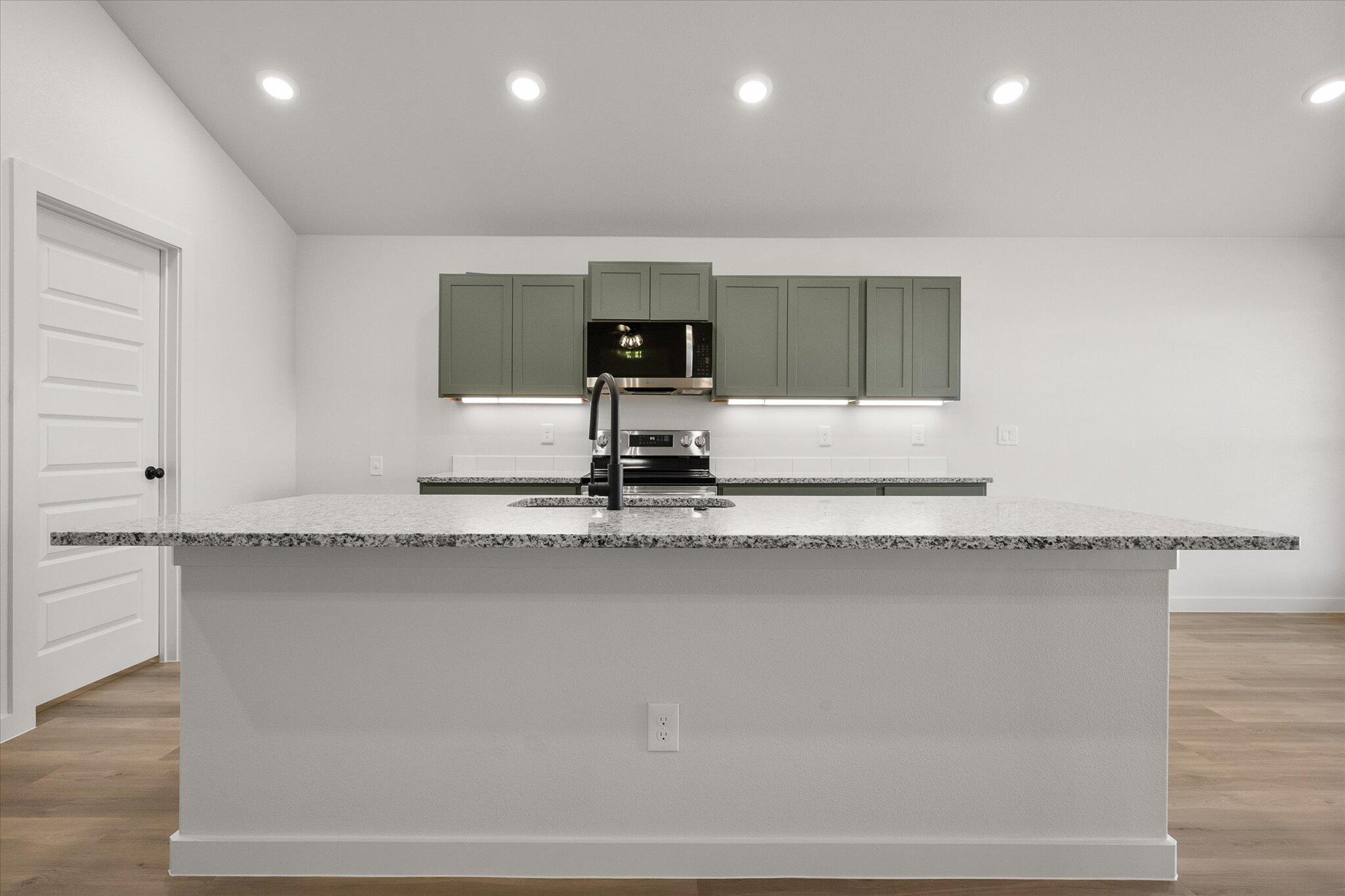 2422 Aberdeen Avenue Wolfforth, TX 79382 - Photo 8 of 23 a kitchen with a sink and cabinets