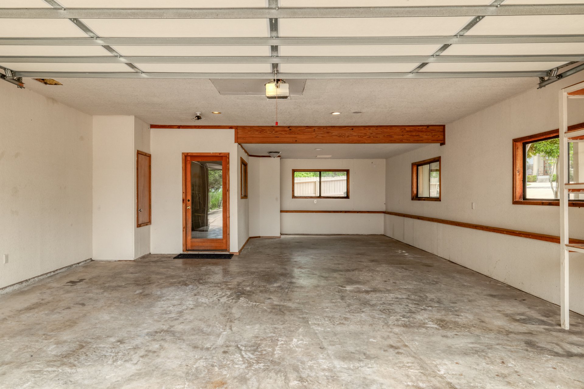 313 Kendall Road Spicewood, TX 78669 - Photo 24 of 34 Garage with a garage door opener