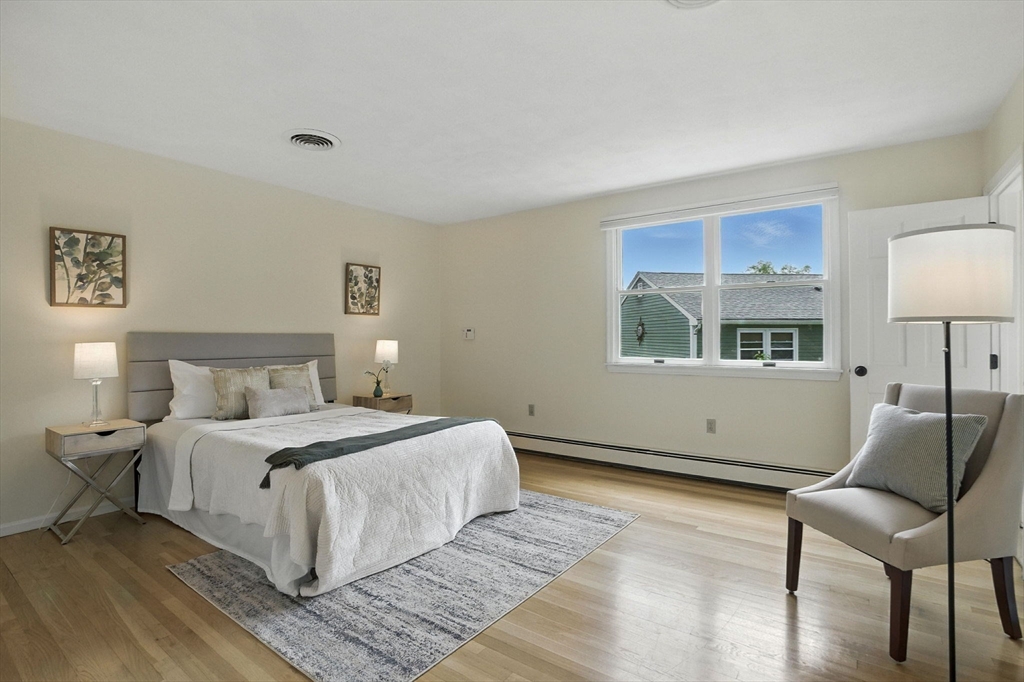 45 Susan Drive Saugus, MA 01906 - Photo 12 of 30 a bedroom with a bed and a chair