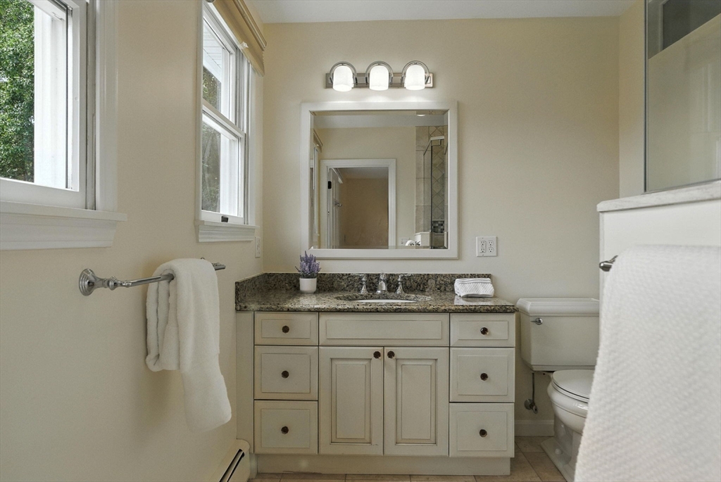 45 Susan Drive Saugus, MA 01906 - Photo 14 of 30 a bathroom with a granite countertop sink and a mirror