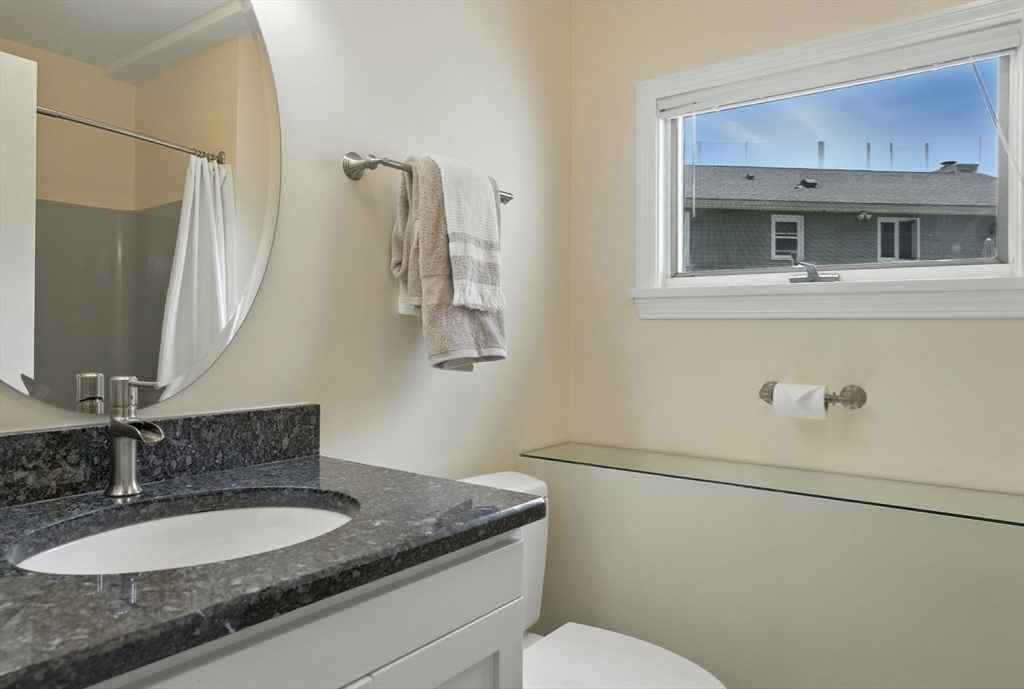 45 Susan Drive Saugus, MA 01906 - Photo 20 of 30 a bathroom with a granite countertop sink and a mirror