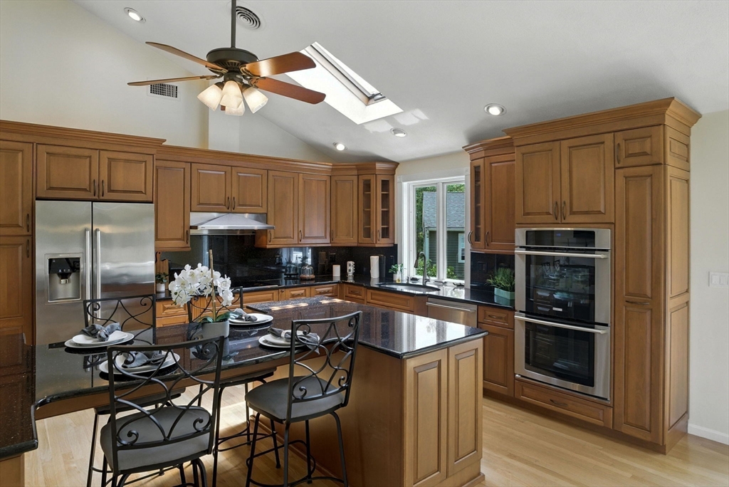45 Susan Drive Saugus, MA 01906 - Photo 2 of 30 a kitchen with a table chairs appliances and cabinets