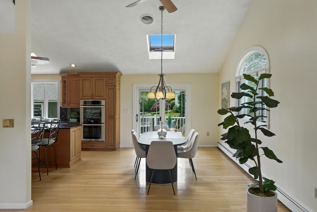 45 Susan Drive Saugus, MA 01906 - Photo 7 of 30 a dining room with furniture a chandelier and wooden floor