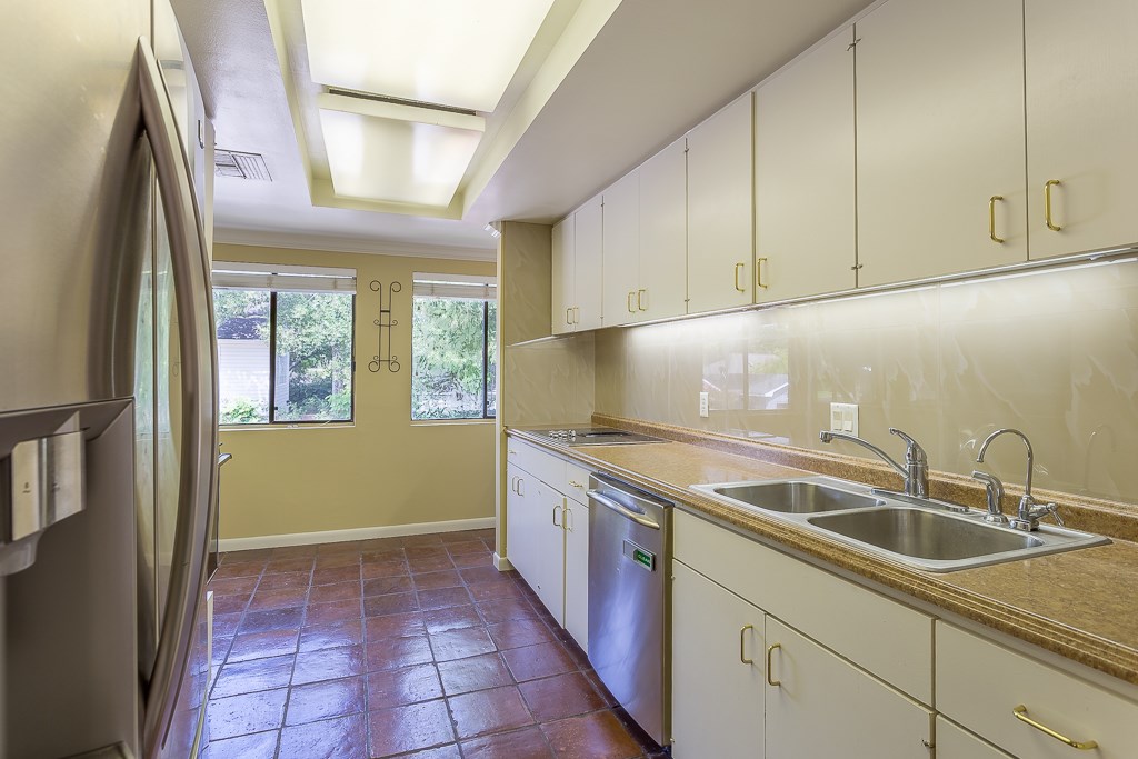 2349 Albans Road, Unit 2 Houston, TX 77005 - Photo 13 of 25 Discover culinary delight in this updated galley kitchen, boasting sleek stainless steel appliances and abundant natural light.