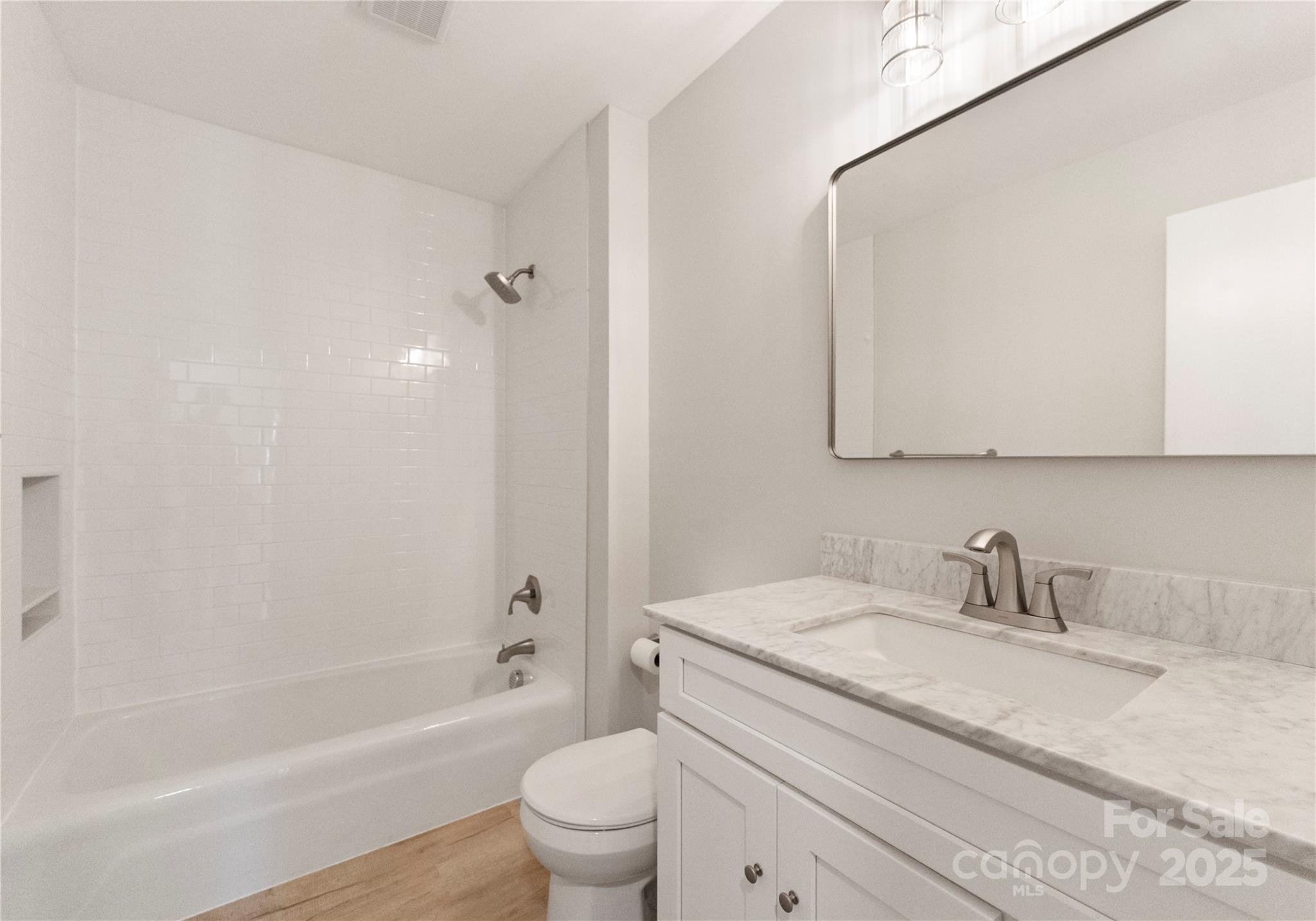 6101 Powder Horn Road Charlotte, NC 28212 - Photo 12 of 27 a bathroom with a granite countertop sink a toilet and shower