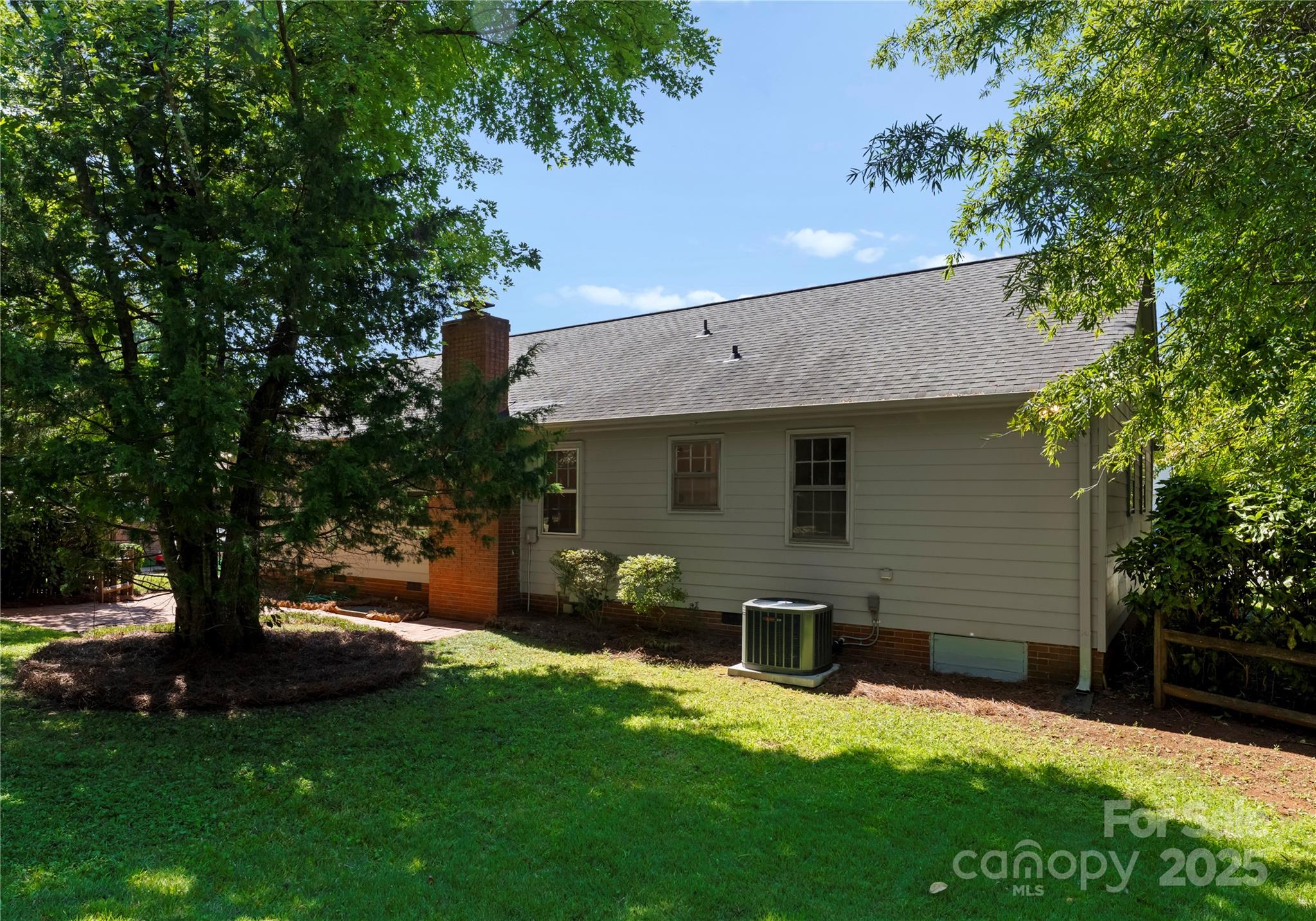 6101 Powder Horn Road Charlotte, NC 28212 - Photo 20 of 27 a view of a backyard with table and chairs and a large tree