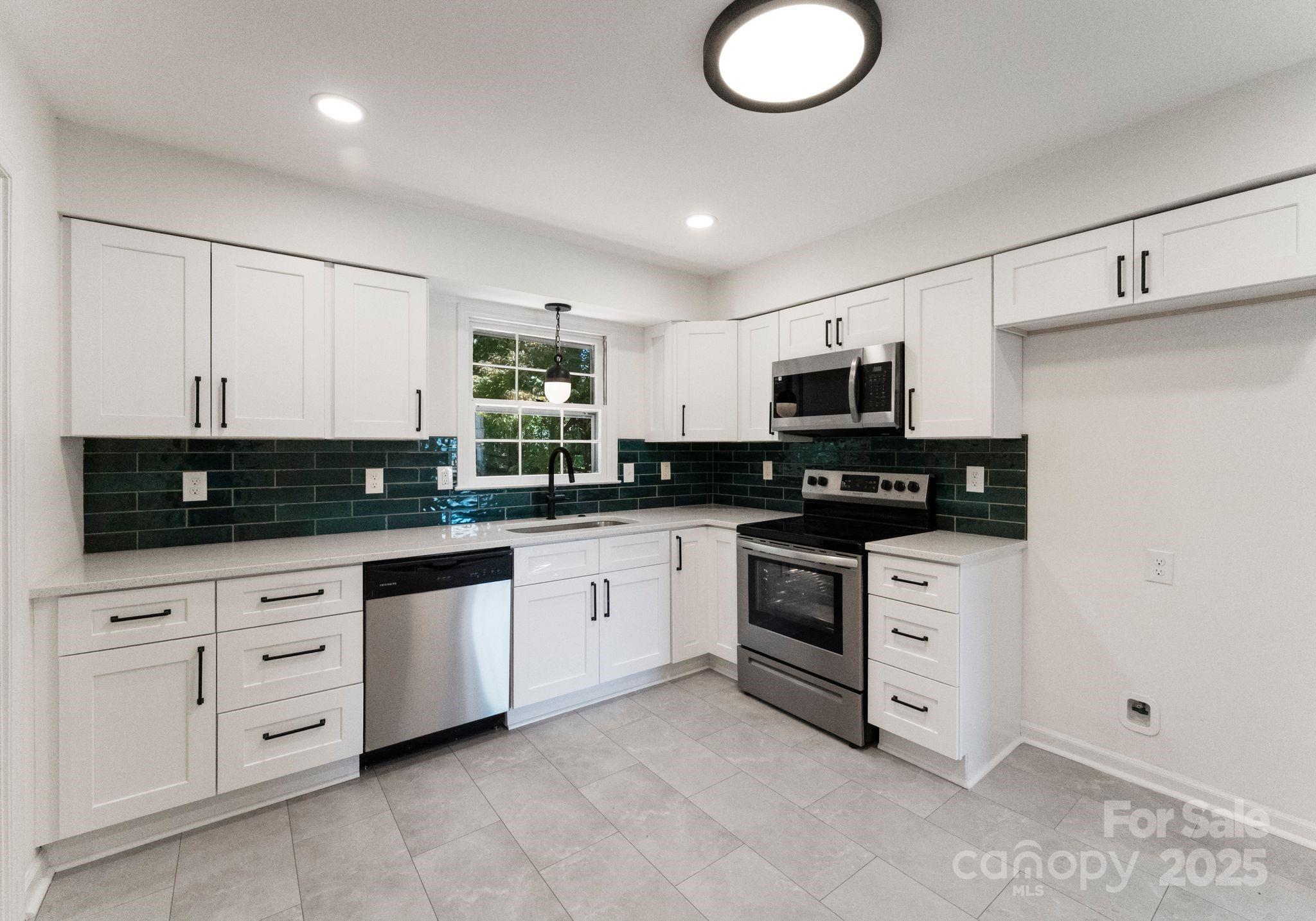 6101 Powder Horn Road Charlotte, NC 28212 - Photo 24 of 27 a kitchen with granite countertop white cabinets stainless steel appliances and a sink