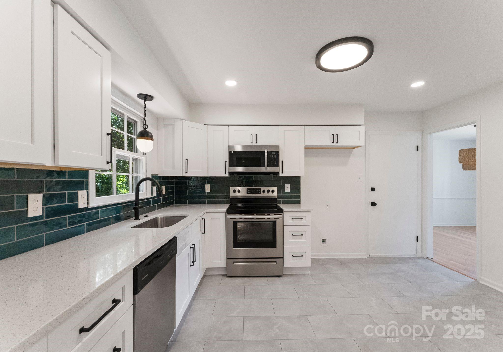 6101 Powder Horn Road Charlotte, NC 28212 - Photo 25 of 27 a kitchen with stainless steel appliances granite countertop a stove and a sink