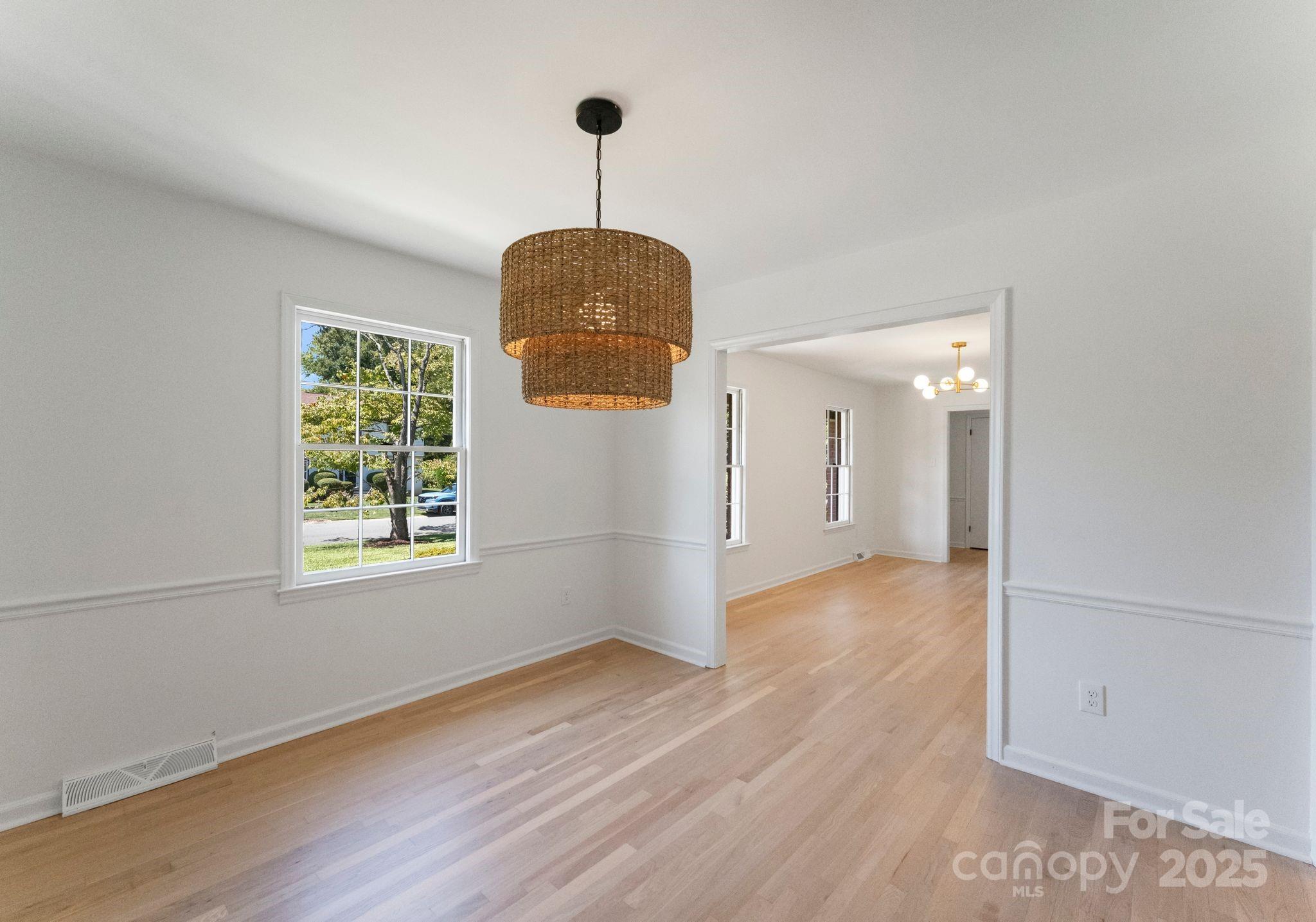 6101 Powder Horn Road Charlotte, NC 28212 - Photo 5 of 27 a view of an empty room with wooden floor and a window