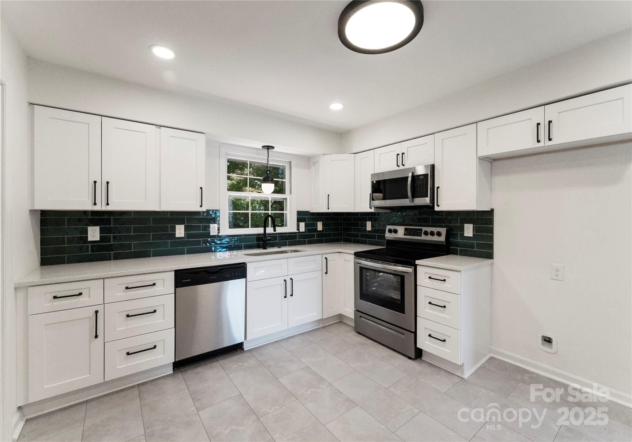 6101 Powder Horn Road Charlotte, NC 28212 - Photo 6 of 27 a kitchen with granite countertop white cabinets stainless steel appliances and a sink