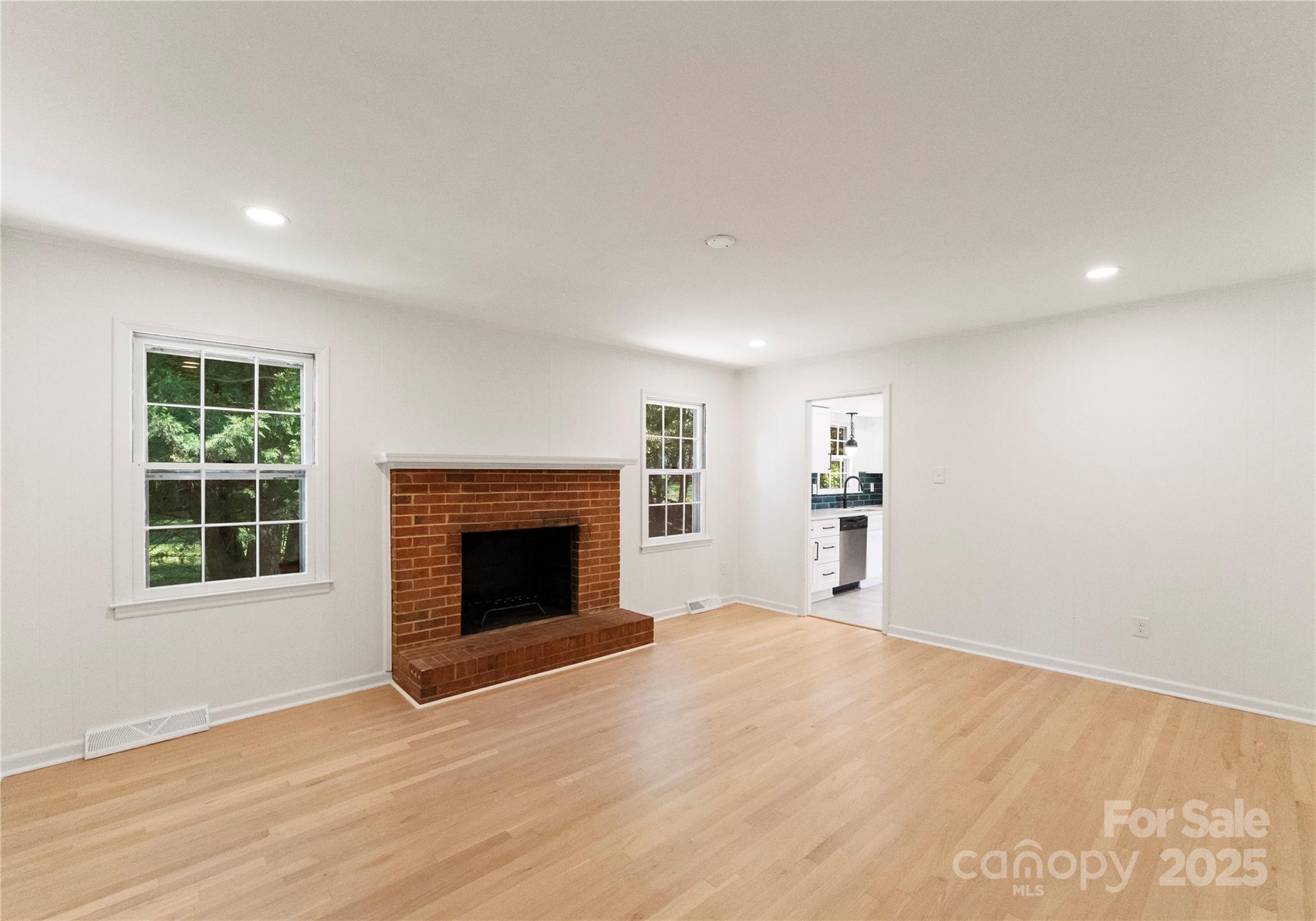 6101 Powder Horn Road Charlotte, NC 28212 - Photo 8 of 27 an empty room with windows and fireplace