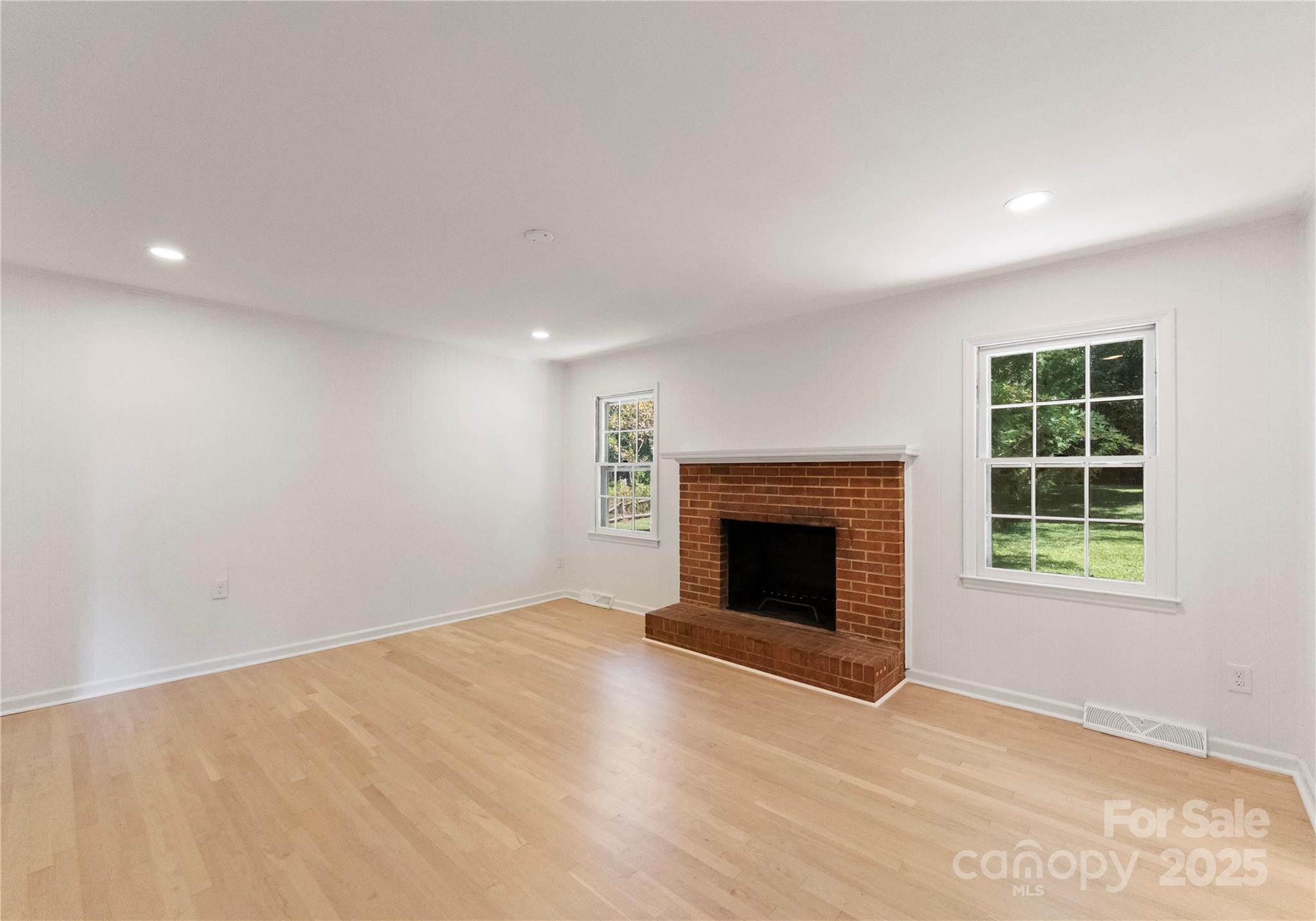 6101 Powder Horn Road Charlotte, NC 28212 - Photo 9 of 27 an empty room with windows and fireplace