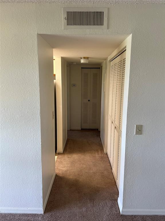 1013 South Hiawassee Road, Unit 3626 Orlando, FL 32835 - Photo 19 of 28 a view of a hallway with wooden floor and a living room