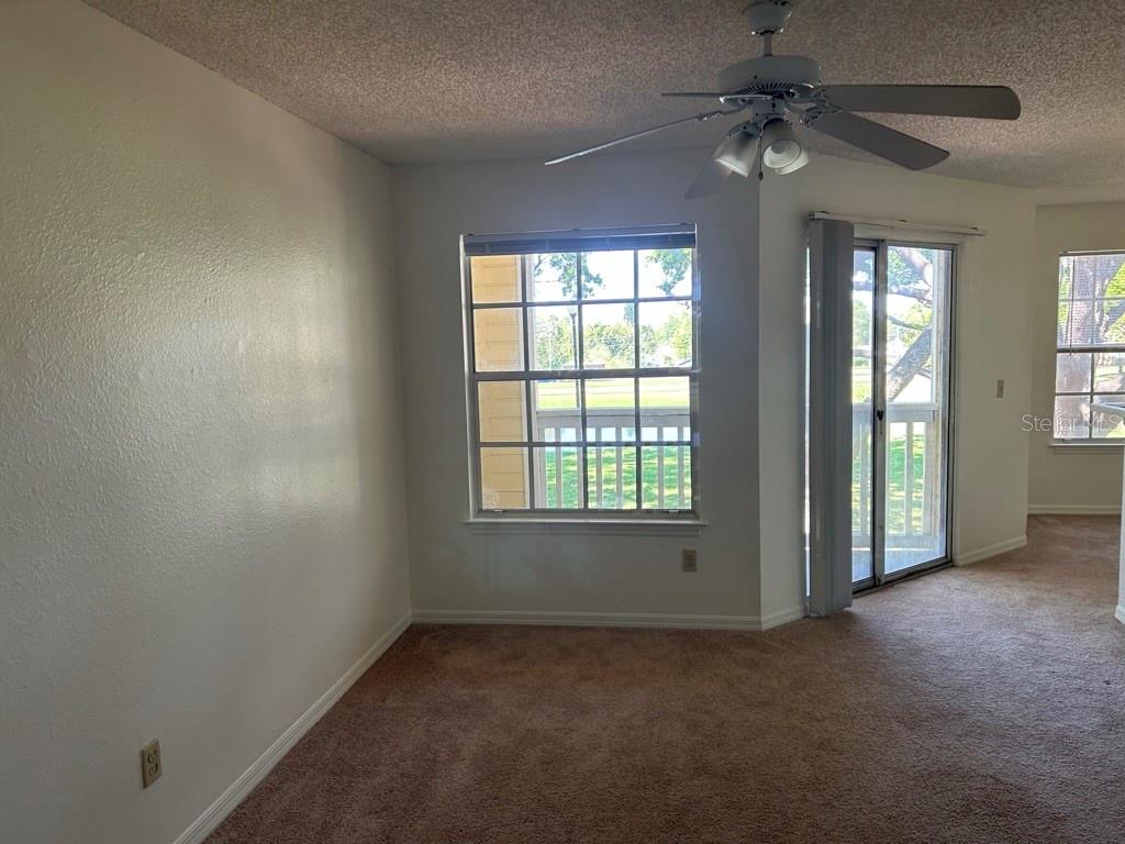 1013 South Hiawassee Road, Unit 3626 Orlando, FL 32835 - Photo 7 of 28 an empty room with a window and a fan