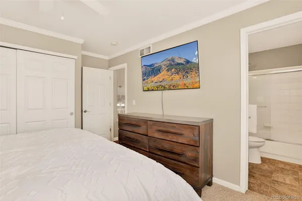 a bedroom with a bed and a view of bathroom