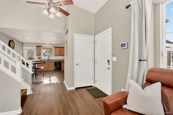 a living room with furniture and a wooden floor
