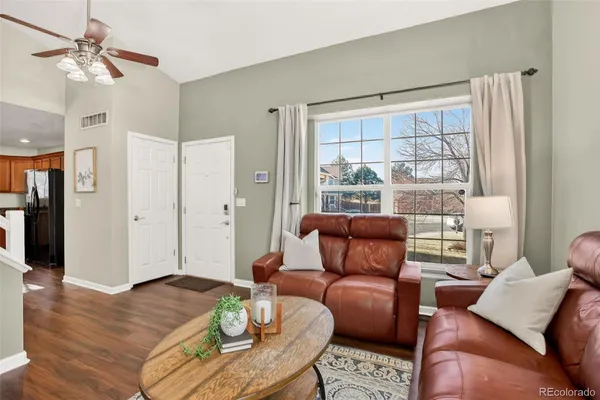 a living room with furniture and wooden floor