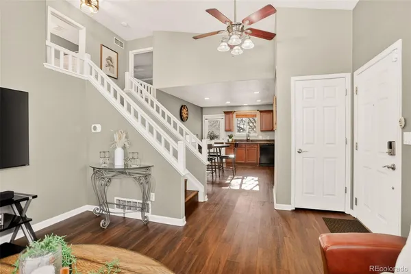 a living room with furniture and a wooden floor