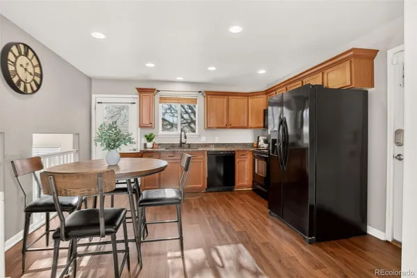 a kitchen with a table and refrigerator