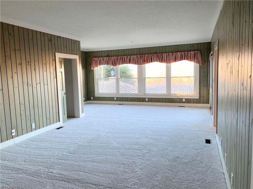 1198 Big Oak Road Germanton, NC 27019 - Photo 21 of 50 Primary suite has brand new carpet, expansive closet and door leading to brick patio.