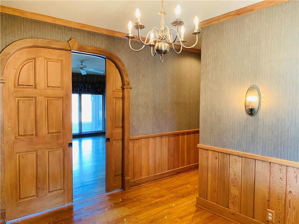 1198 Big Oak Road Germanton, NC 27019 - Photo 5 of 50 Arched pocket doors lead into living room/great room with massive stone fireplace.